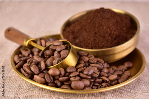 Ground coffee and coffee beans in a copper bowl. Close-up.
