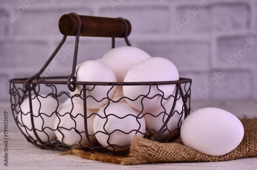 Chicken eggs in a metal basket. Close-up.
