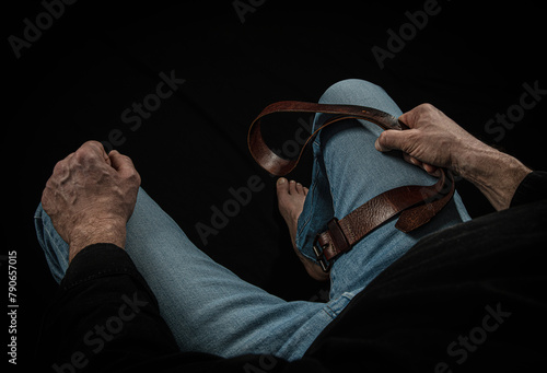Strict man with leather belt.