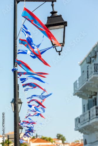 Obraz na płótnie Local flags and ensign in Spetses island during the festivities for the most popular local festival, the Armata. The Greek flag and the local flag of the island are on display. w salonie
