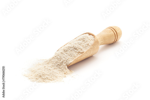 Front view of a wooden scoop filled with Organic Wheat Flour (Triticum). Isolated on a white background.