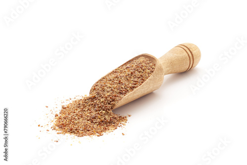 Front view of a wooden scoop filled with Organic Flaxseed Flour (Linum usitatissimum). Isolated on a white background.