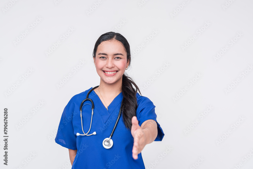 Friendly young Asian female nurse with a welcoming handshake, isolated on white Friendly young Asian female nurse with a welcoming handshake, isolated on white