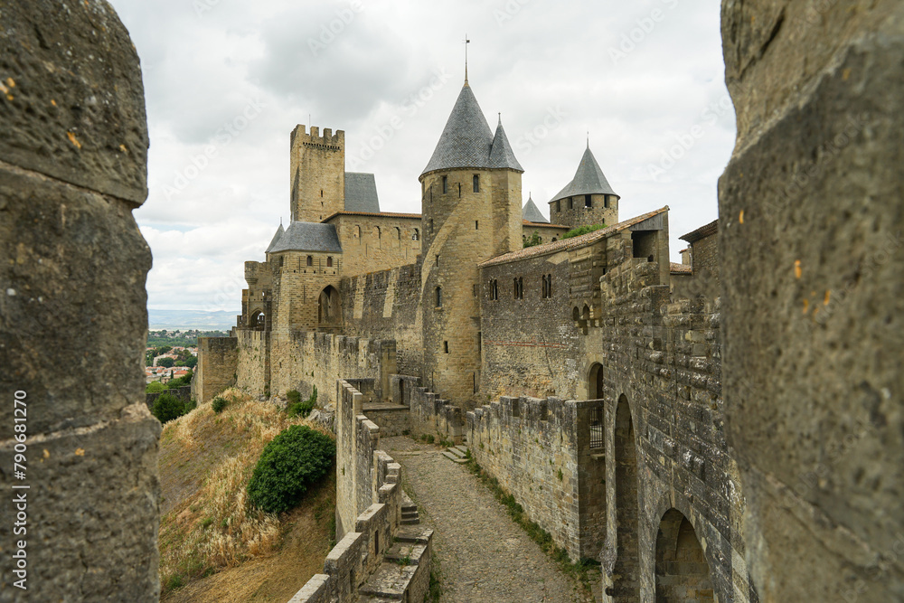 Carcassone castle with ramparts and towers on sunny day, popular tourist landmark in France