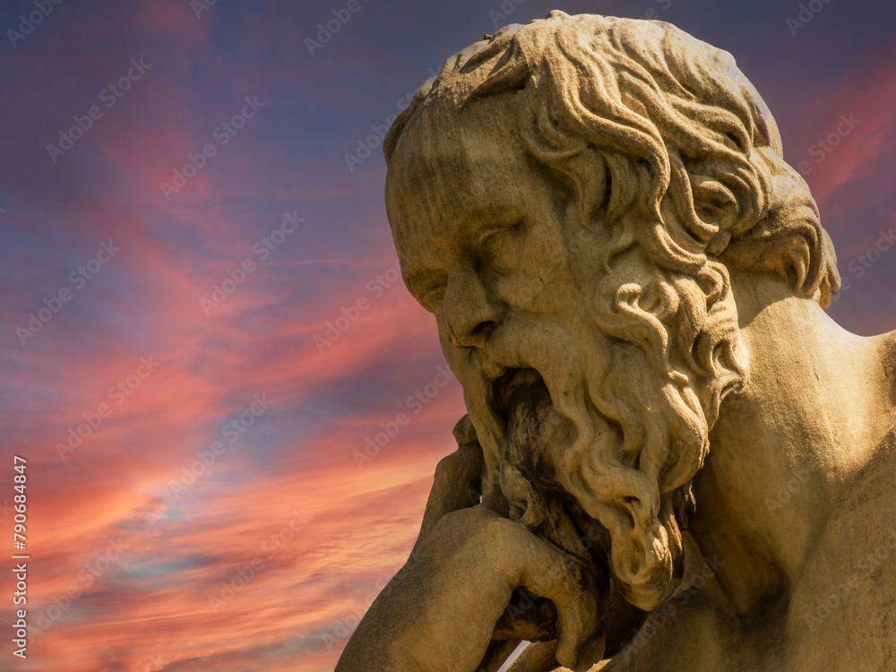 Socrates bust marble statue, the ancient Greek philosopher, under a fiery sky. Travel to Athens, Greece.