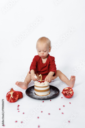 happy birthday cake of one year baby on white background with red pomegranate