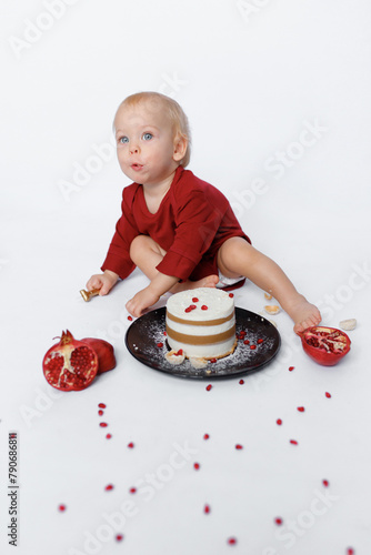 happy birthday cake of one year baby on white background with red pomegranate