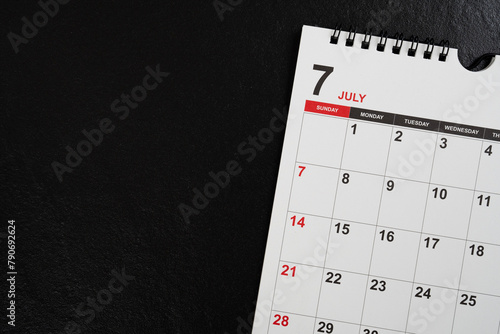 close up of calendar on the black table background, planning for business meeting or travel planning concept