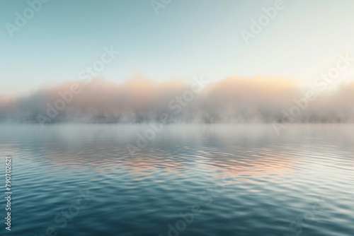 Dense fog rolling over a tranquil lake at sunrise. © Papisut