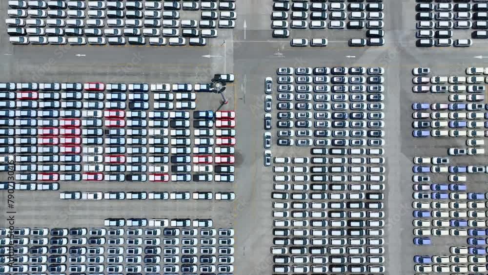 A bird's-eye panorama reveals an expanse of electric cars, harmonizing with nature in a sprawling lot designed for eco-friendly transportation.
A bird's-eye panorama reveals an expanse of electric cars, harmonizing with nature in a sprawling lot designed for eco-friendly transportation.