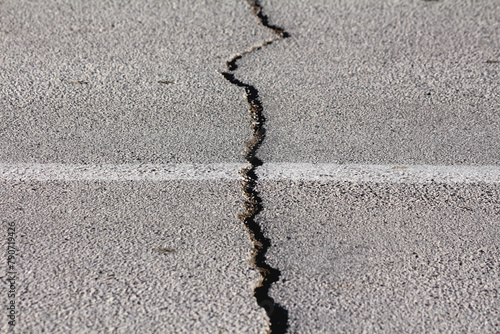 Fotografi Large crack on public paved asphalt road that appeared after big earthquake wait
