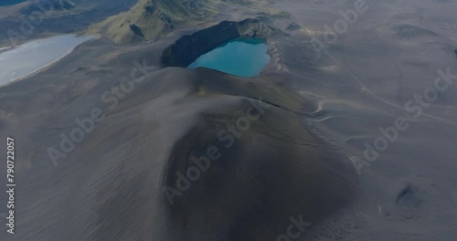 Aerial Tilt Up Shot Of Ljotipollur Lake Amidst Rock Formations, Drone Flying Forward Over Lava Landscape - Unknown, Iceland photo