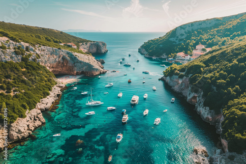 Captivating drone view capturing the scenic panorama of Stiniva cove filled with tourist boats, an iconic spot on Vis Island, Croatia.