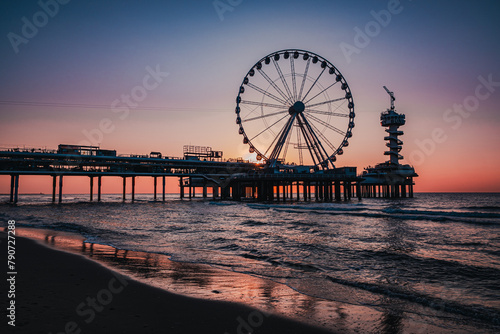 Sunset at the Beach with a Silhouetted Ferris Wheel in Scheveningen