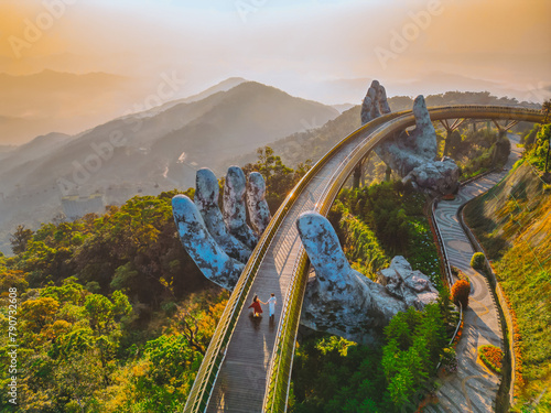 Young  traveler Couple  Walking on the Golden Bridge in Bana hills, enjoying the morning , Danang Vietnam