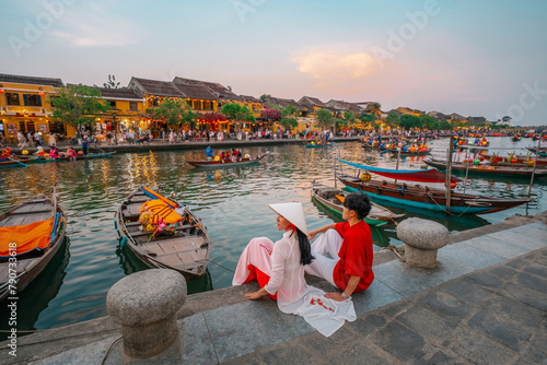 Asian Couple wearing vietnam  traditional culture  walking around at Hoi An ancient town,Hoi an city in Vietnam.