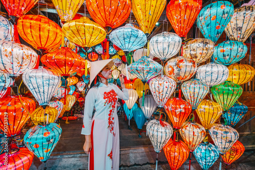 Asian woman wearing vietnam  traditional culture  choosing lanterns  at Hoi An ancient town Hoi an city in Vietnam.