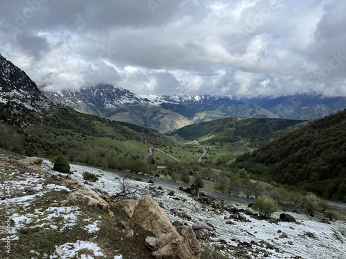 Tseylomsky pass in Ingushetia. A trip uphill to the Tsei Loam pass on a cloudy spring day. Panorama of the high cliffs of the Dzheyrakh gorge. North Caucasus, Russia