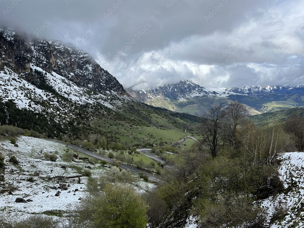 Tseylomsky pass in Ingushetia. A trip uphill to the Tsei Loam pass on a cloudy spring day. Panorama of the high cliffs of the Dzheyrakh gorge. North Caucasus, Russia Tseylomsky pass in Ingushetia. A trip uphill to the Tsei Loam pass on a cloudy spring day. Panorama of the high cliffs of the Dzheyrakh gorge. North Caucasus, Russia