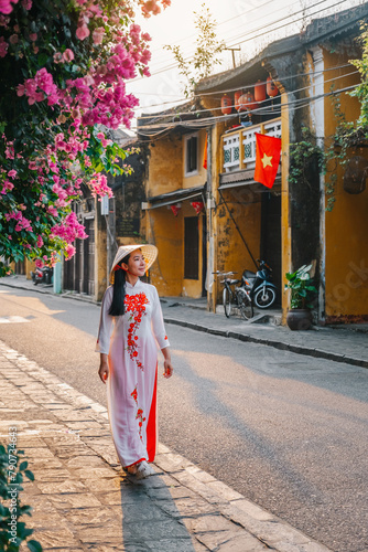 Asian woman wearing vietnam  traditional culture  walking around at Hoi An ancient town,Hoi an city in Vietnam.