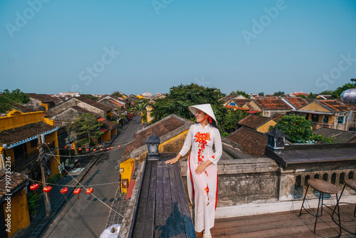 Asian woman wearing vietnam  traditional culture  walking around at Hoi An ancient town,Hoi an city in Vietnam.