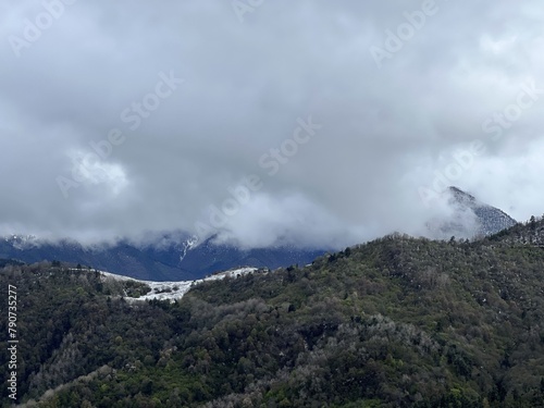 Tseylomsky pass in Ingushetia. A trip uphill to the Tsei Loam pass on a cloudy spring day. Panorama of the high cliffs of the Dzheyrakh gorge. North Caucasus, Russia photo