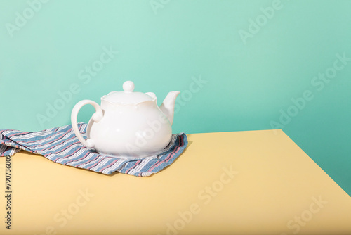 porcelain teapot craft stillife on colorful ground photo