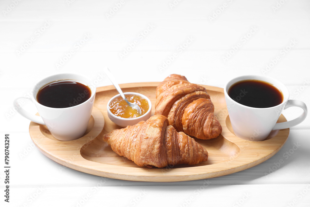 Tasty breakfast. Cups of coffee, jam and croissants on white wooden table Tasty breakfast. Cups of coffee, jam and croissants on white wooden table