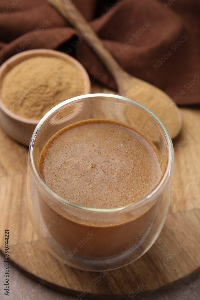 Soluble fiber with water in glass, powder and spoon on table, closeup Soluble fiber with water in glass, powder and spoon on table, closeup