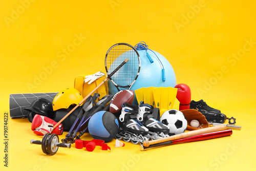 Many different sports equipment on yellow background © New Africa