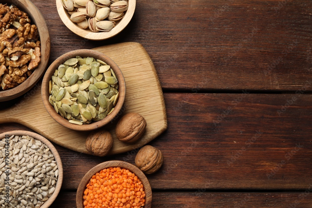 Different products high in vegetable fats on wooden table, flat lay. Space for text Different products high in vegetable fats on wooden table, flat lay. Space for text