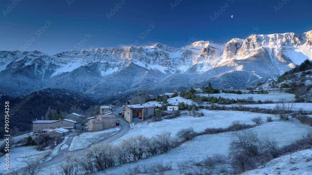 Timelapse of the town of Estana and the Serra del Cadí range on a winter sunrise with snow and the waning Moon (Cerdanya, Lleida, Catalonia, Spain, Pyrenees) Timelapse of the town of Estana and the Serra del Cadí range on a winter sunrise with snow and the waning Moon (Cerdanya, Lleida, Catalonia, Spain, Pyrenees)