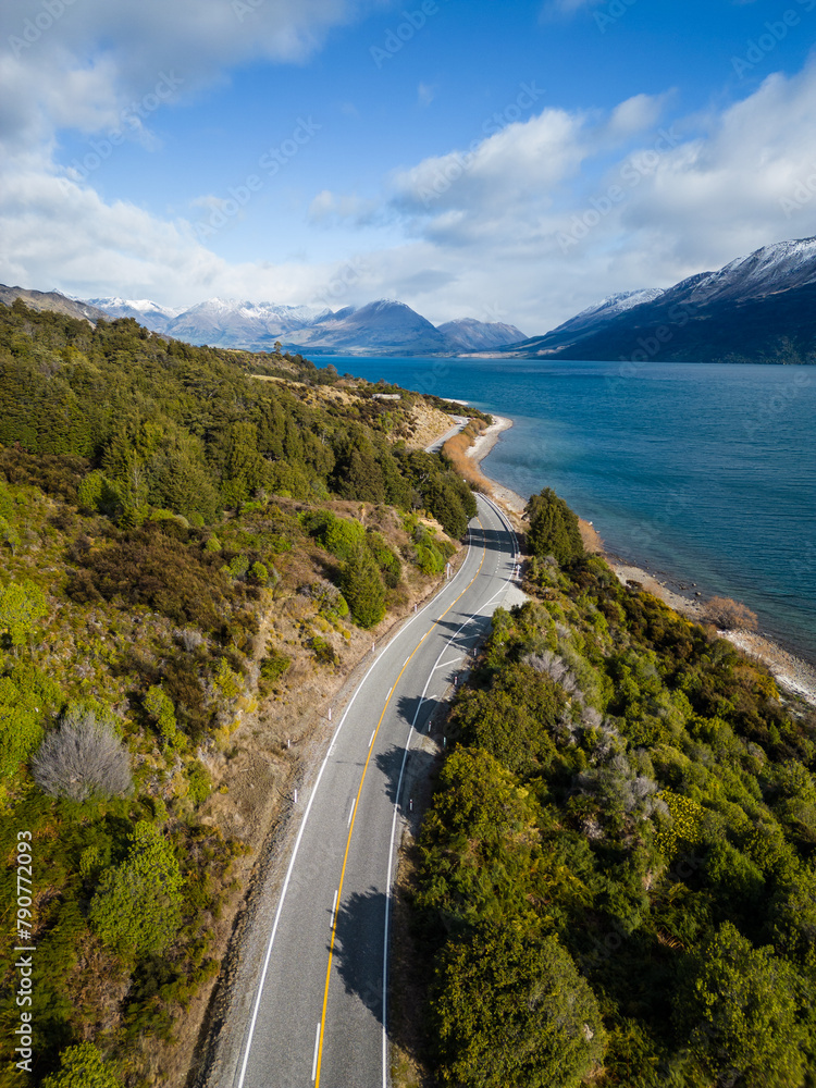 Queenstown, New Zealand: Aerial view of the coastal road along the lake Wakapitu leading to Glenorchy from Queenstown in New Zealand south island on a sunny winter day