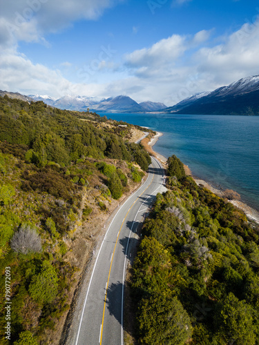 Queenstown, New Zealand: Aerial view of the coastal road along the lake Wakapitu leading to Glenorchy from Queenstown in New Zealand south island on a sunny winter day