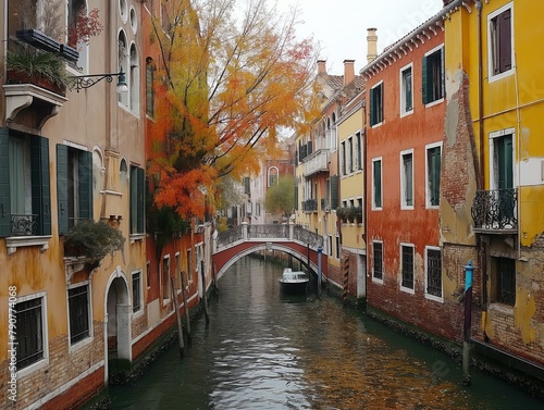 A canal with a boat in it and houses on either side. The houses are yellow and red © MaxK