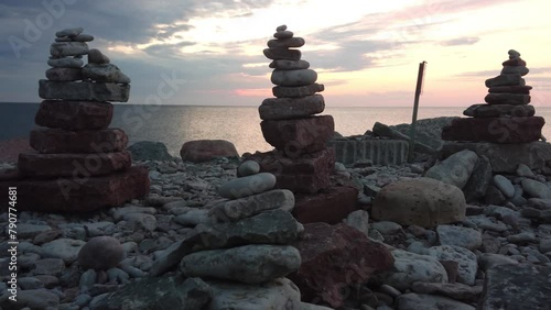 Panorama of the embankment with stone figures stacked on it against the backdrop of sunset Byxelkrok, Sweden. High quality 4k footage photo