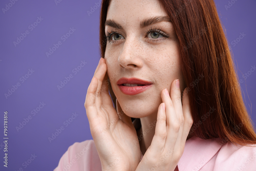 Portrait of beautiful woman with freckles on purple background, closeup Portrait of beautiful woman with freckles on purple background, closeup