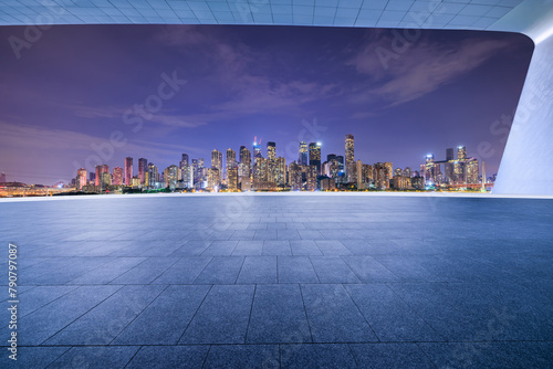 Empty square floors and city skyline with modern buildings at night © ABCDstock