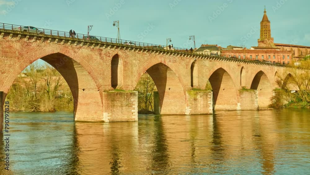 Old Bridge over Tarn River in Montauban. Church of Saint-Jacques de Montauban. Montauban is commune in Tarn-et-Garonne department in Occitanie region in southern France. Old Bridge over Tarn River in Montauban. Church of Saint-Jacques de Montauban. Montauban is commune in Tarn-et-Garonne department in Occitanie region in southern France.