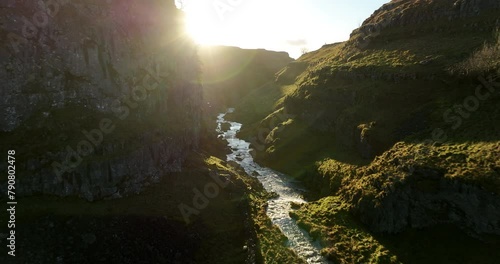 Flying in a rocky gorge at sunrise. photo