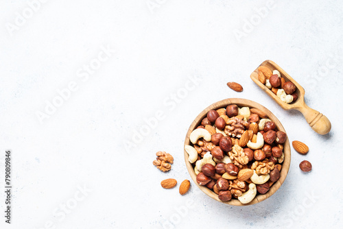 Nuts assortment at white background. Almond, hazelnut, cashew in wooden bowl. Top view