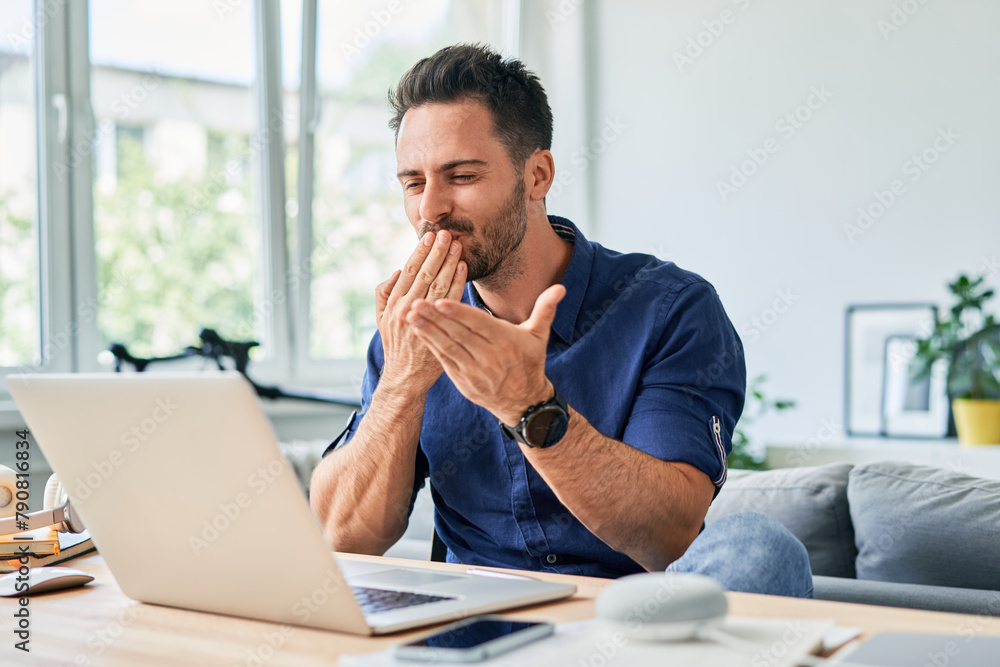 Handsome man blowing a kiss during video call on laptop Handsome man blowing a kiss during video call on laptop