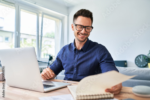 Happy businessman working from home