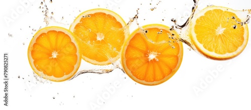 Orange slices splashing in water