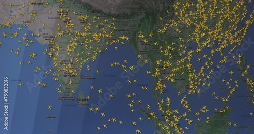 Time lapse of busy air traffic over map on digital screen.
