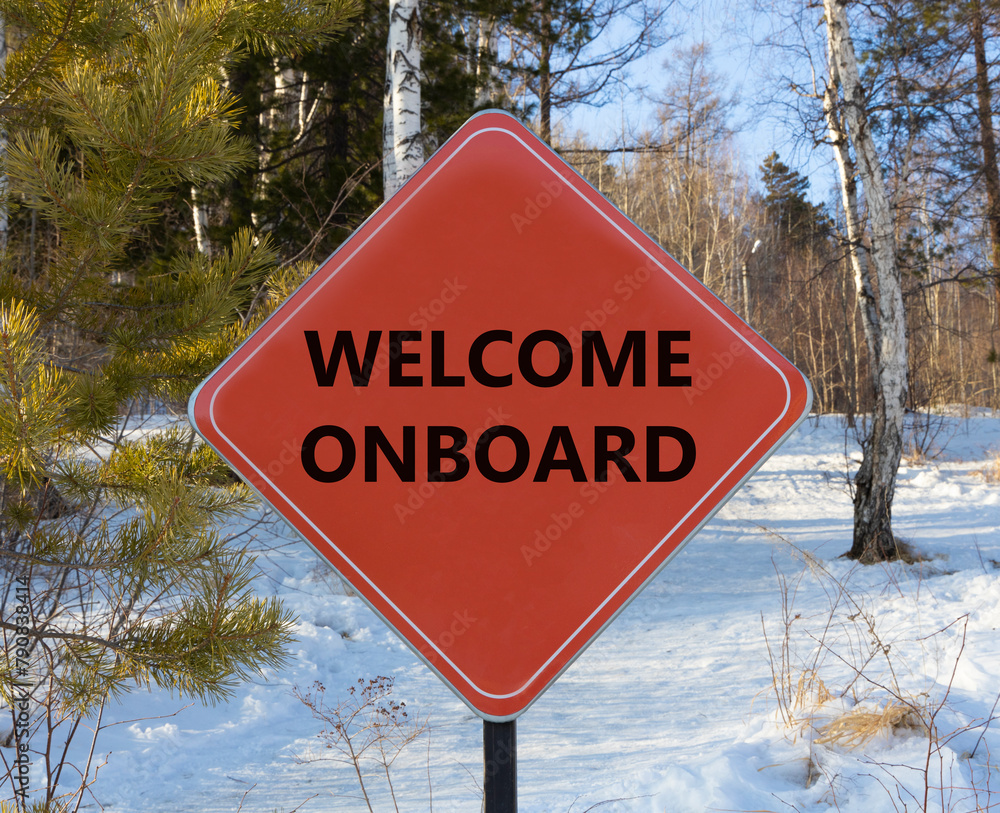Welcome onboard symbol. Concept words Welcome onboard on beautiful red road sign. Beautiful forest snow blue sky background. Business, motivational welcome onboard concept. Copy space.