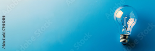 Divine guidance mentor web banner. Light bulb with halo on blue background with copy space. photo