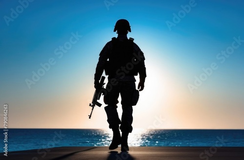 Silhouette of a military man with a weapon on the background of the sunset sky, a man with a machine gun, military actions, sunset photo
