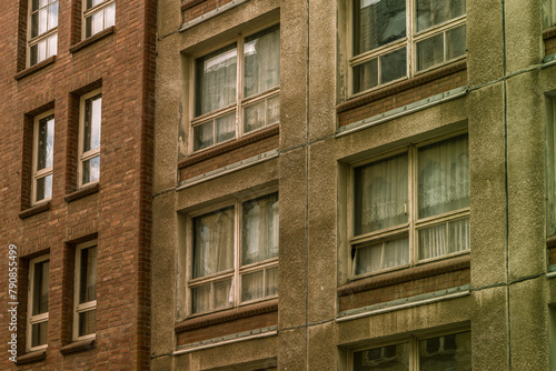 vintage brick building with windows and a brown facade