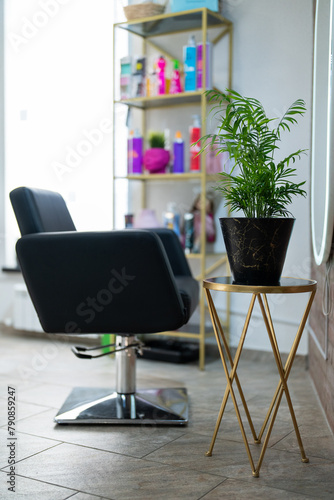 A large black chair in the interior of a beauty salon. Chair in a beauty salon.